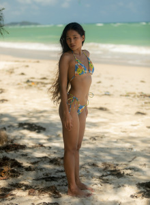 Asian brunette Kloyali in motley bikini goes nude on the beach