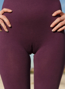 Busty brunette Paisleyc Osiris wearing tight violet spandex suit with cameltoe and stretching nipples