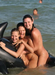 Puffy nipples girls in the sea with a toy dolphine